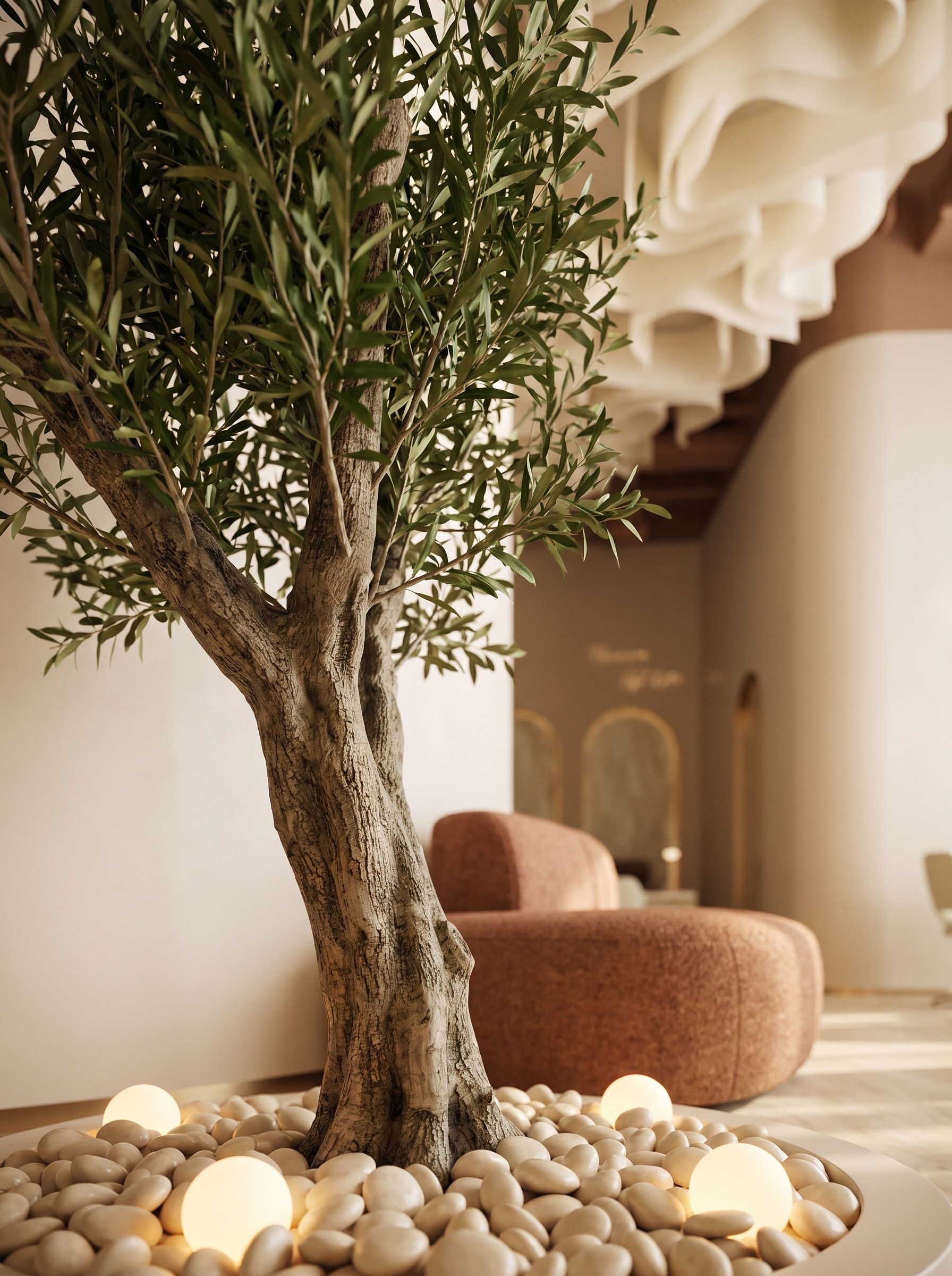 The Glowin lounge: soft seating beneath the sculpted ceiling, an olive tree in the light